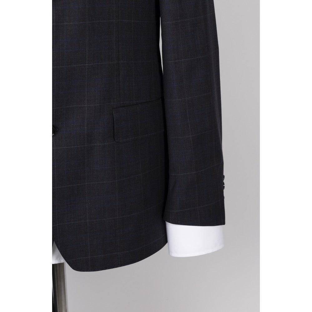 Sleeve and cuff detail of the navy windowpane check wool jacket, with four buttons at the cuff and a white shirt cuff beneath.