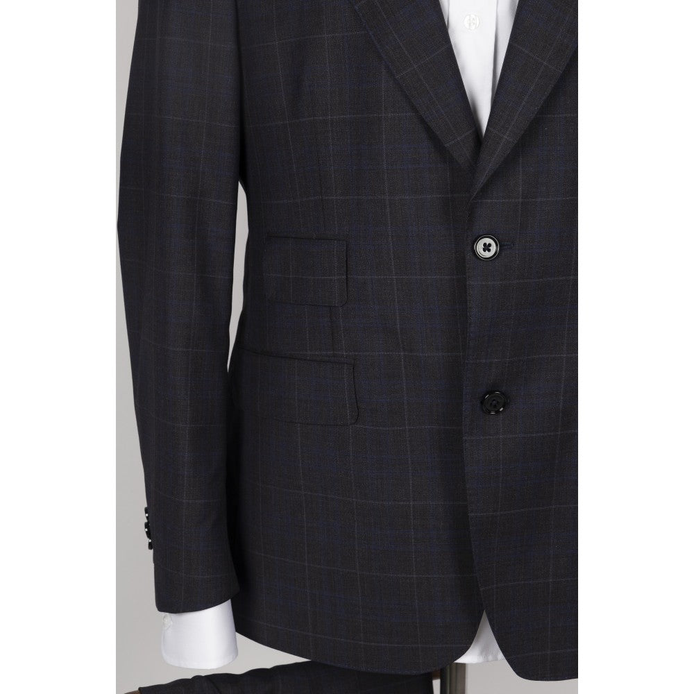 Front of the navy windowpane check suit jacket showing the two-button closure, flap pocket and ticket pocket.